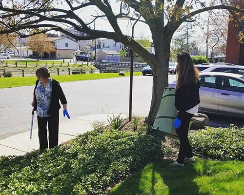 Community - Strickler Insurance Team Member Cleaning Up Near Curb
